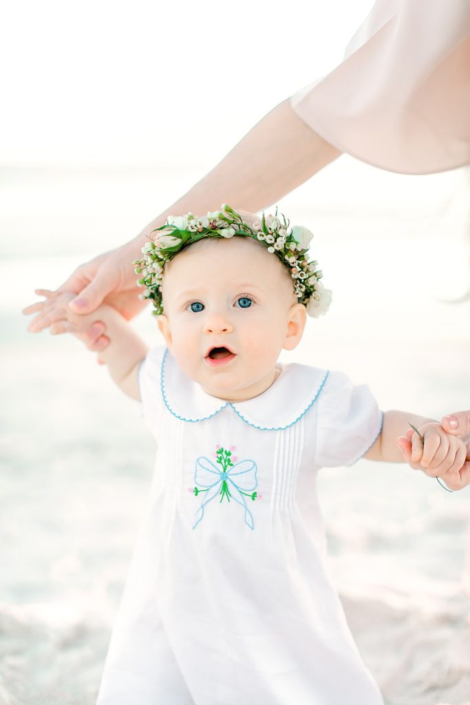 baby girl with flower crown on the beach