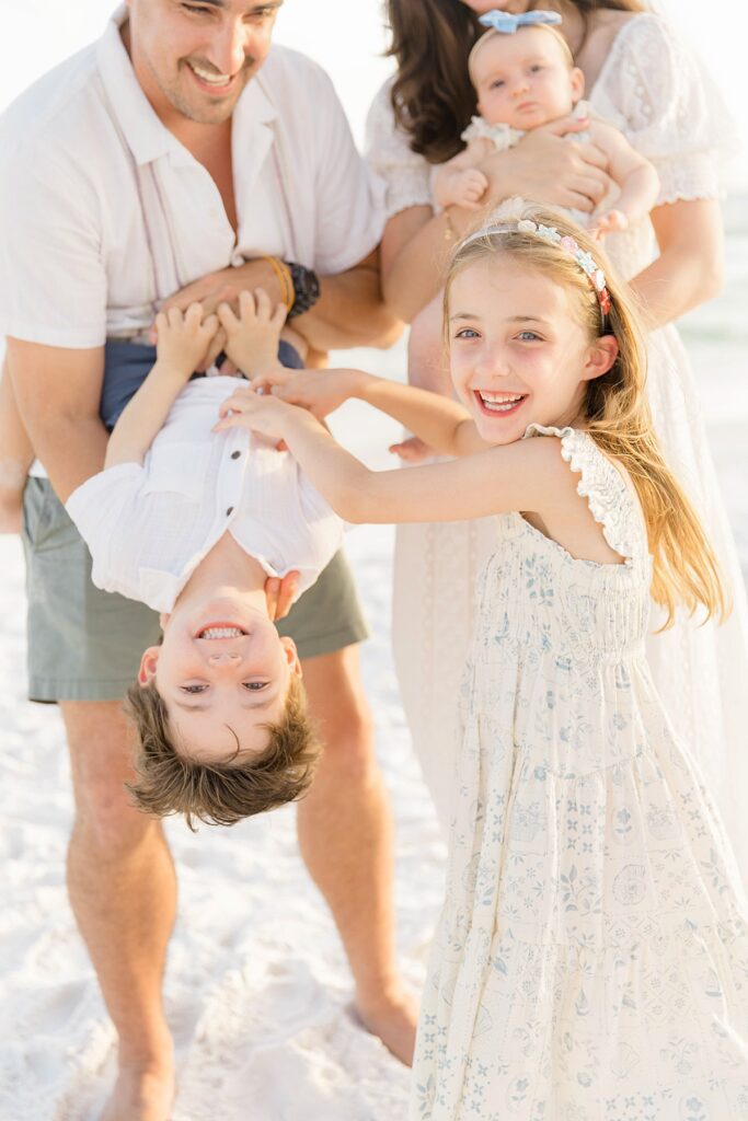 Daughter and son playfully interacting on Destin beach