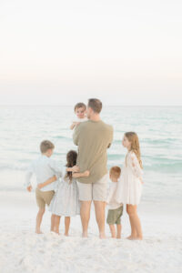 A delightful image showcasing a father with children, dressed in mix-and-matched neutral colors. The scene exudes a harmonious blend of coordinated yet diverse outfits, capturing the essence of family fashion in neutral tones.